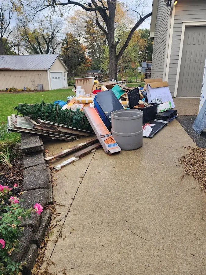 Dumpster being loaded with debris for Residential Dumpster Rental in Bellville